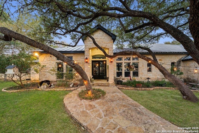 view of front of home featuring a front yard and french doors