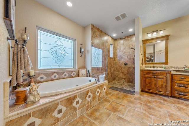 bathroom featuring vanity and separate shower and tub