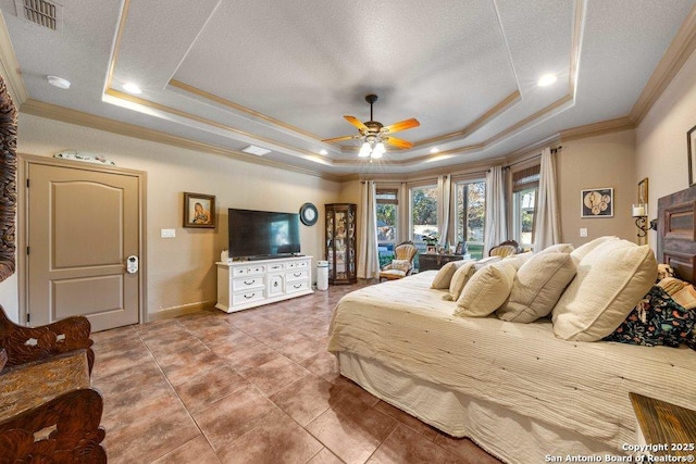 bedroom with ceiling fan, tile patterned flooring, crown molding, a textured ceiling, and a tray ceiling