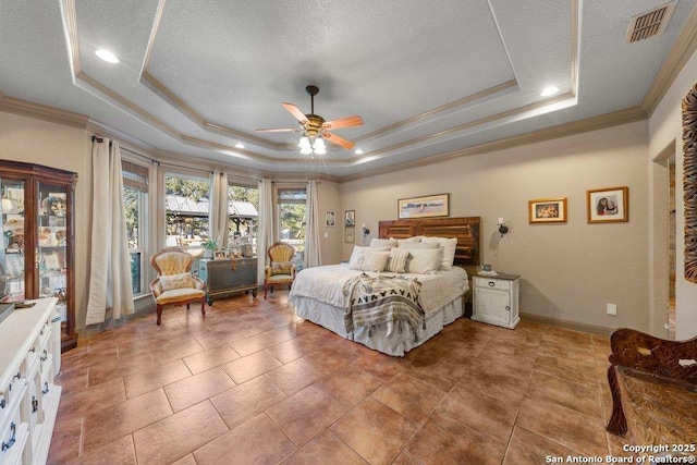 bedroom with a raised ceiling, ceiling fan, crown molding, and a textured ceiling