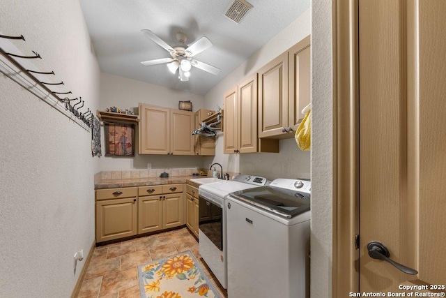 laundry room featuring washer and dryer, ceiling fan, cabinets, and sink