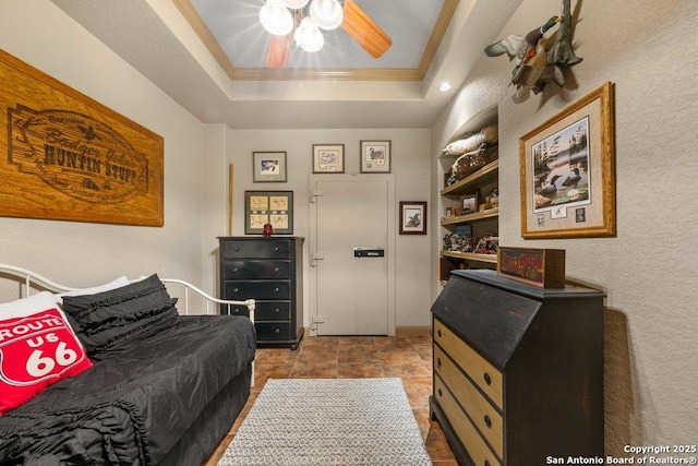 bedroom with a raised ceiling, ceiling fan, and crown molding