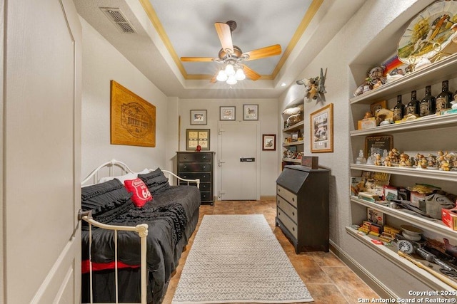 bedroom with a raised ceiling, ceiling fan, and crown molding