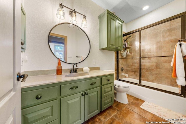 full bathroom featuring vanity, toilet, and bath / shower combo with glass door