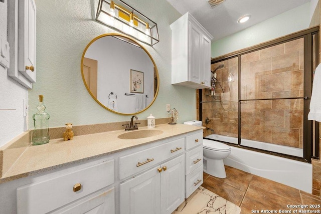 full bathroom with tile patterned flooring, vanity, toilet, and bath / shower combo with glass door