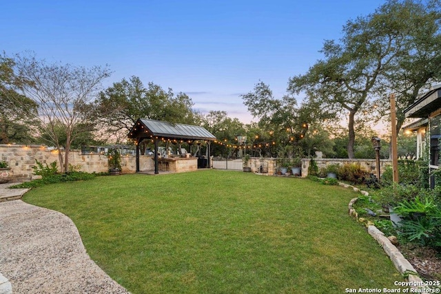 yard at dusk with a gazebo