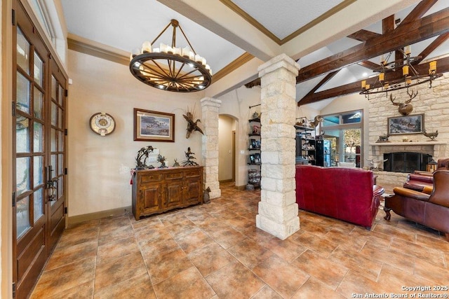 living room with a fireplace, french doors, decorative columns, and high vaulted ceiling