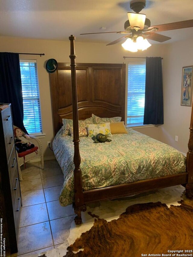 tiled bedroom with ceiling fan