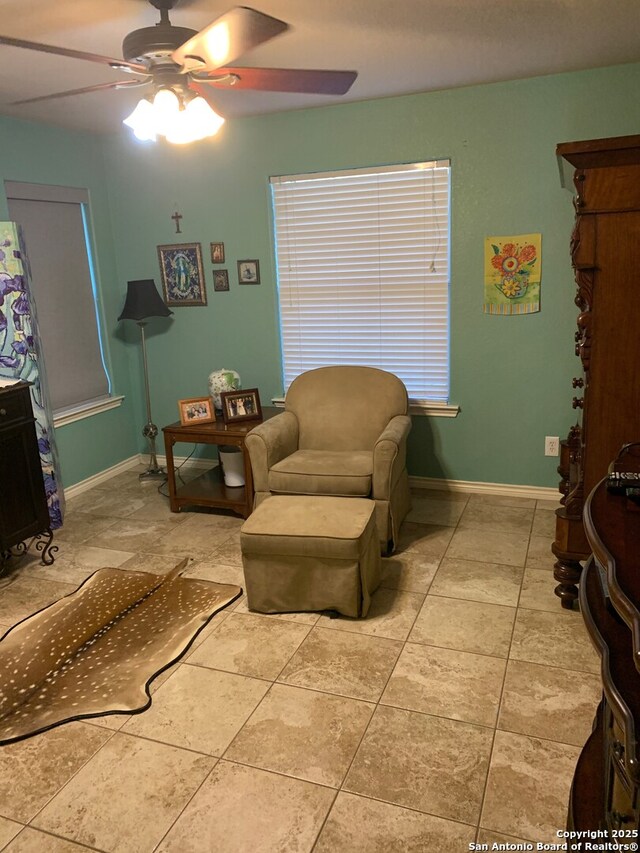 sitting room with tile patterned floors and ceiling fan