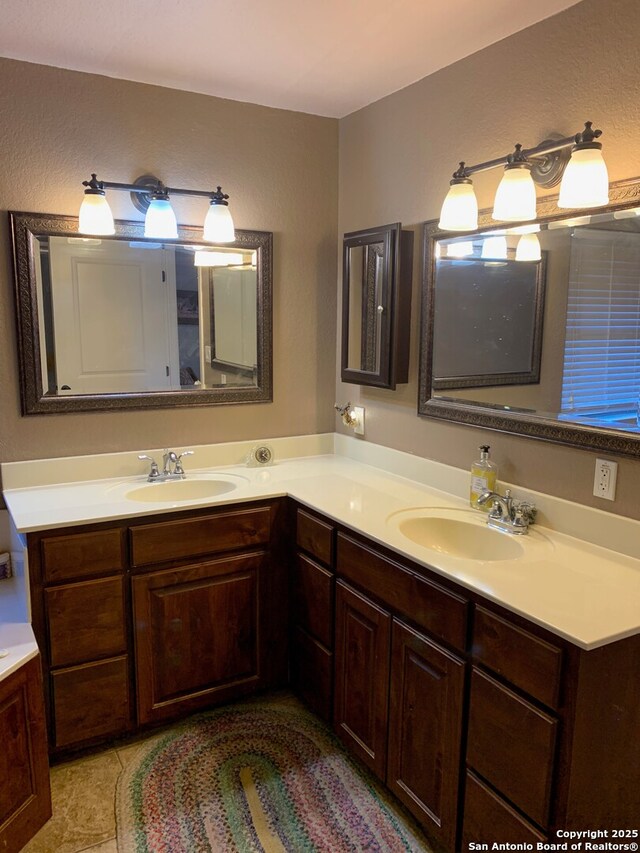 bathroom with tile patterned flooring and vanity