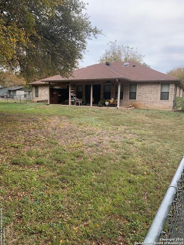 back of property featuring a lawn