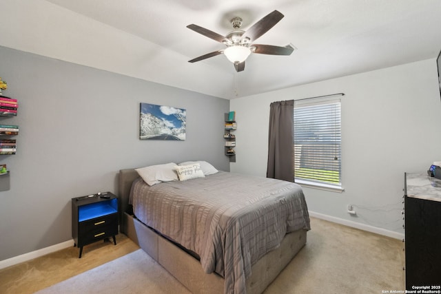 bedroom featuring ceiling fan and light carpet