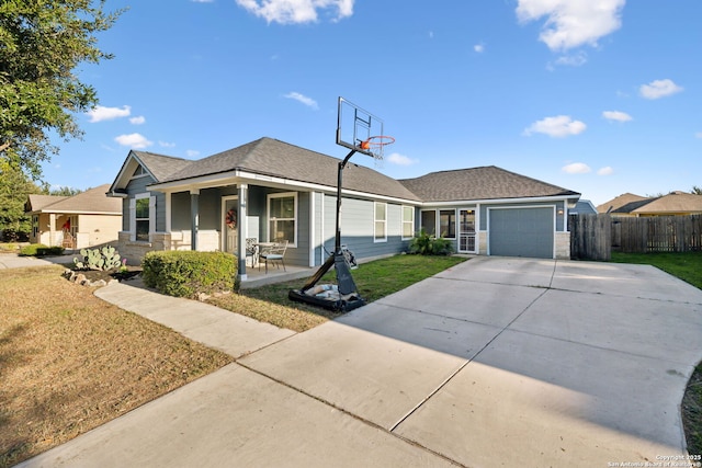 view of front of house featuring a porch, a garage, and a front yard