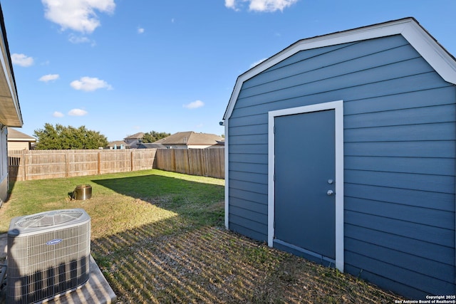 view of outdoor structure with central AC unit and a lawn