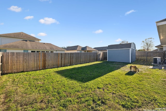 view of yard with central AC unit and a storage unit