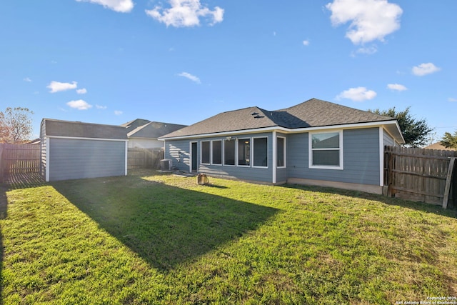 back of property with central AC unit, a storage unit, and a lawn