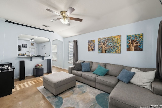 living room with ceiling fan and lofted ceiling