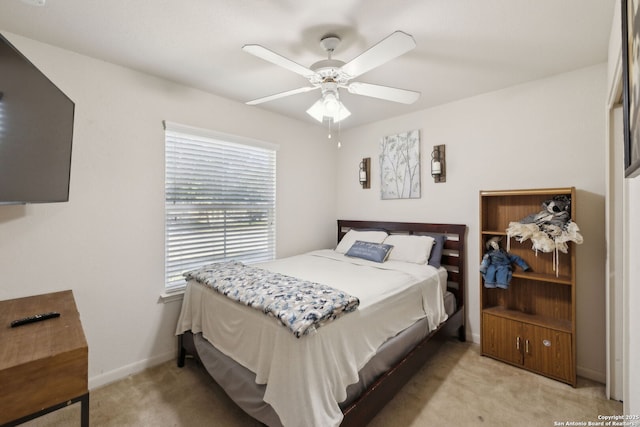 bedroom with ceiling fan and light colored carpet