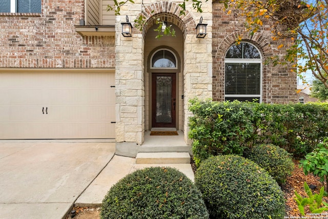 doorway to property with a garage