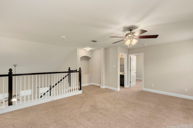 spare room with ceiling fan and light carpet