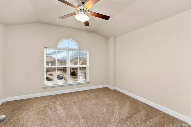 carpeted empty room with ceiling fan and lofted ceiling