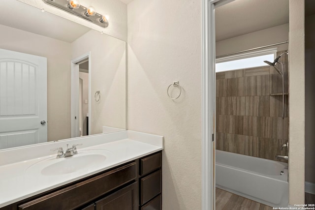 bathroom featuring bathtub / shower combination, vanity, and hardwood / wood-style flooring