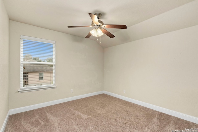 carpeted empty room featuring ceiling fan and lofted ceiling