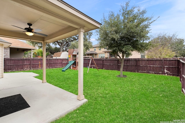 view of yard featuring a playground, ceiling fan, and a patio area