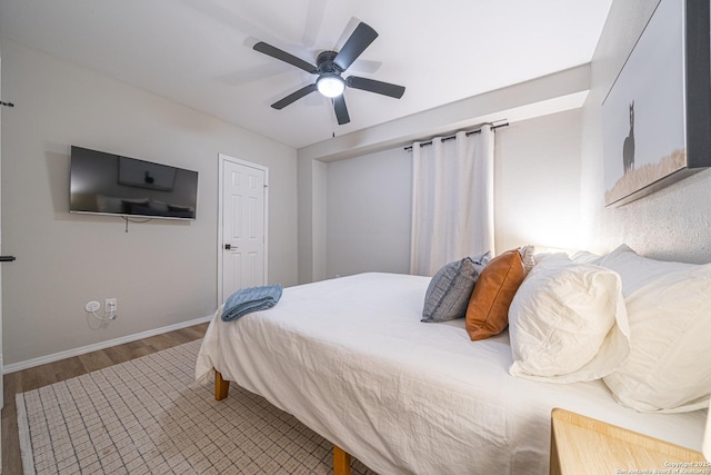 bedroom with wood-type flooring and ceiling fan