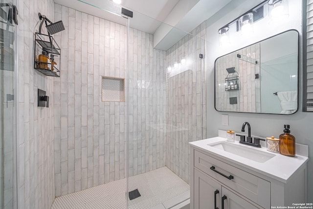 bathroom featuring vanity and a shower with door