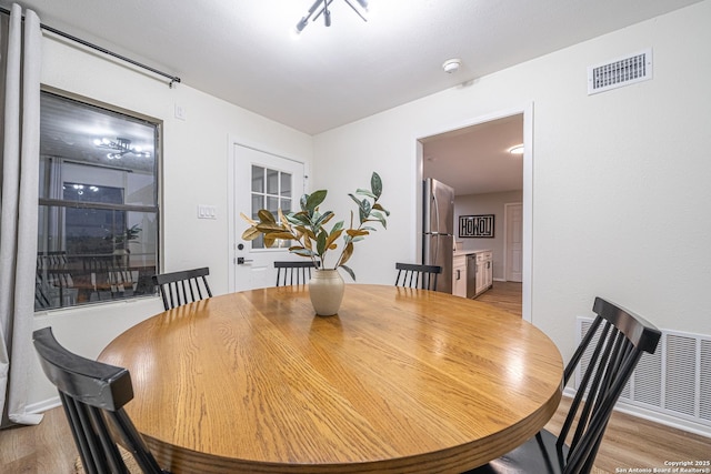 dining space featuring light wood-type flooring