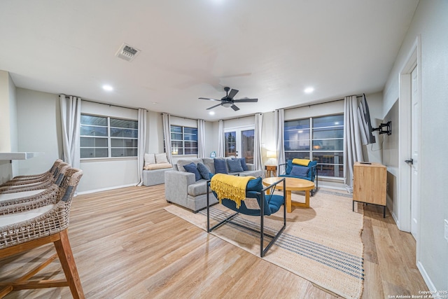 living room with light wood-type flooring and ceiling fan