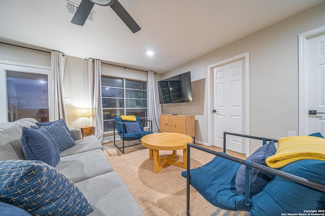 living room with ceiling fan and light hardwood / wood-style floors