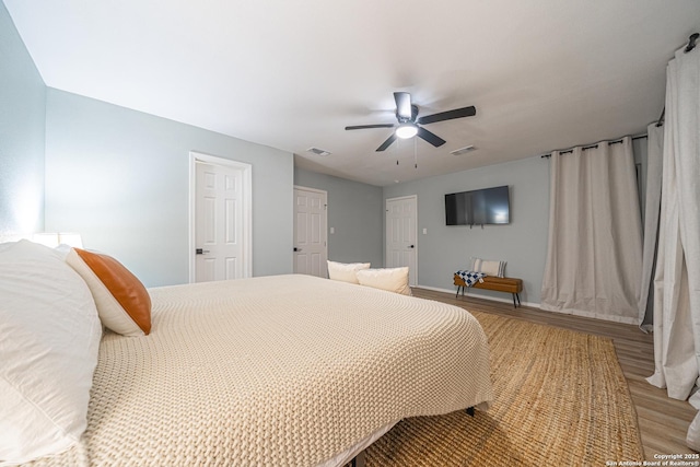 bedroom with wood-type flooring and ceiling fan