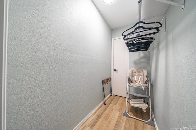 corridor with light hardwood / wood-style floors