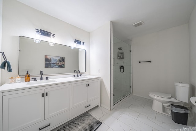 bathroom with vanity, a shower with shower door, and toilet