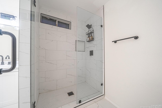 bathroom featuring a shower with shower door