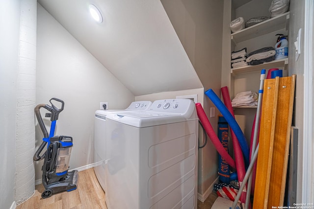 laundry area with washing machine and dryer and wood-type flooring