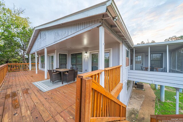 deck featuring a sunroom and cooling unit