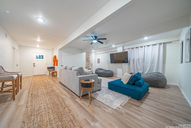 living room with ceiling fan and light hardwood / wood-style floors