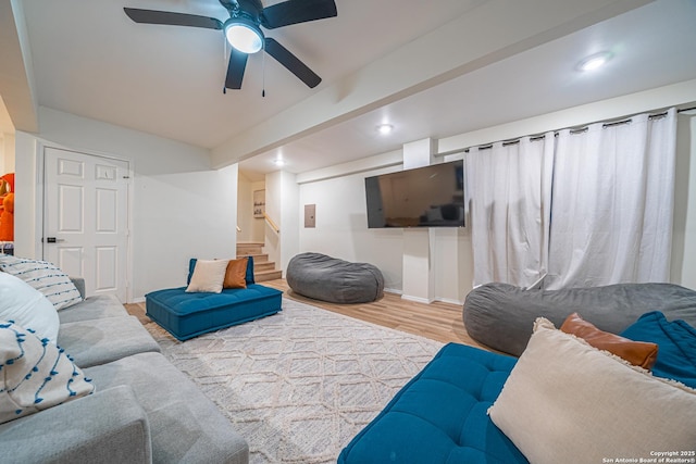 living room with light hardwood / wood-style floors and ceiling fan