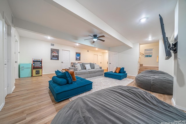 living room with wood-type flooring and ceiling fan