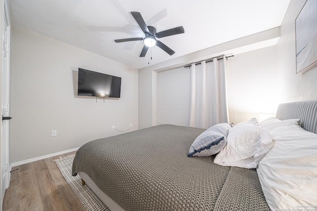 bedroom with ceiling fan and hardwood / wood-style flooring