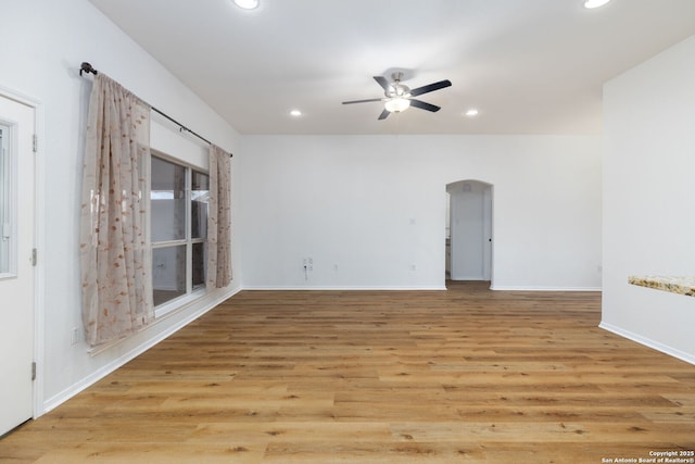 empty room with ceiling fan and light wood-type flooring