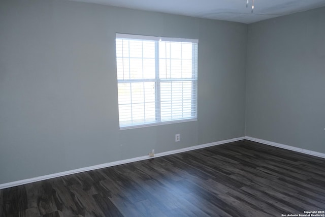 unfurnished room featuring dark wood-type flooring