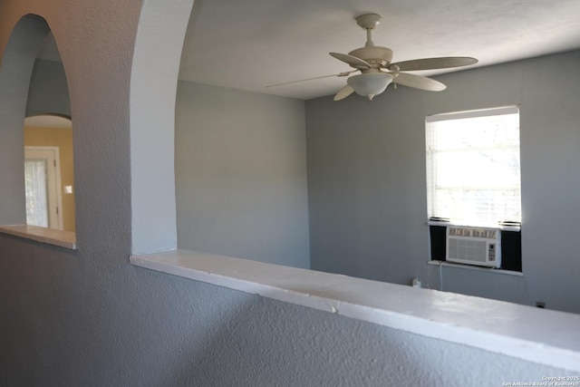 interior space featuring ceiling fan and cooling unit