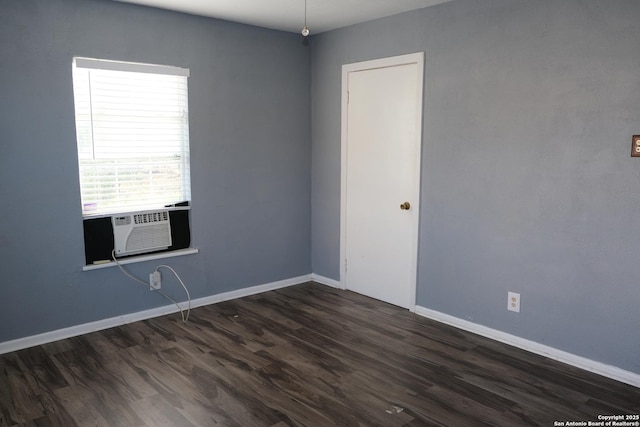 unfurnished room featuring cooling unit and dark hardwood / wood-style flooring