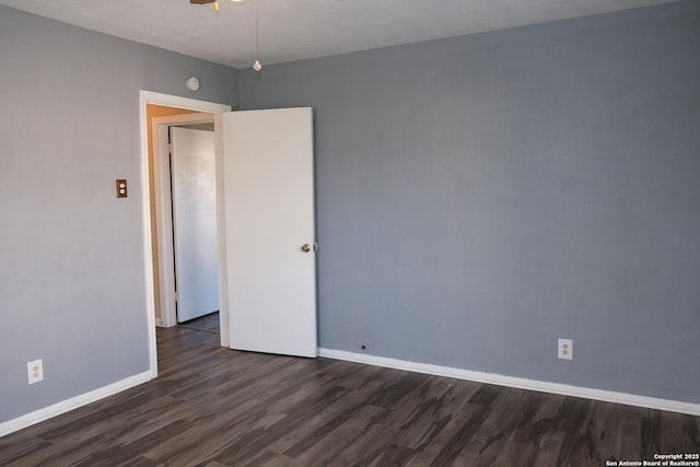 spare room with dark hardwood / wood-style floors