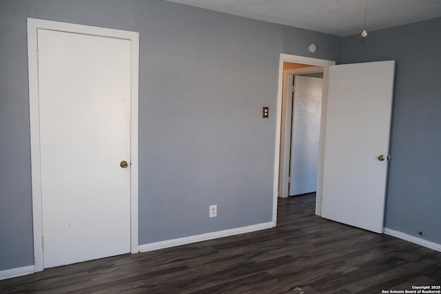 unfurnished bedroom featuring dark hardwood / wood-style floors