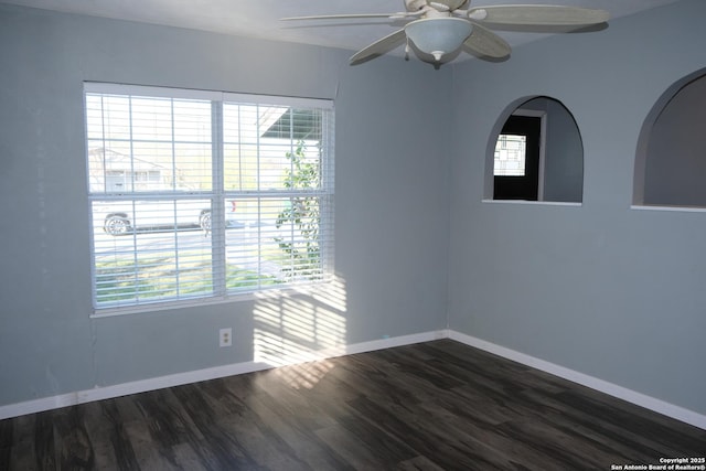 unfurnished room with ceiling fan and dark hardwood / wood-style floors